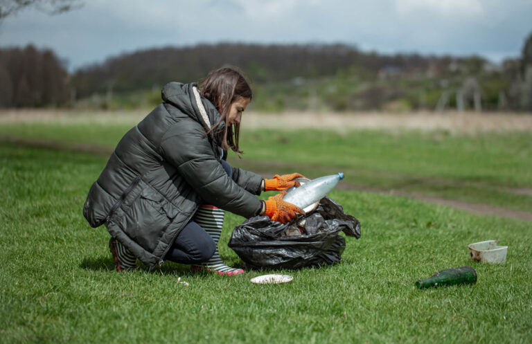 girl-volunteer-collects-garbage-forest-takes-care-environment (1) (1)